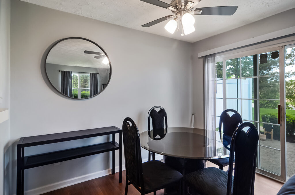 Dining area with round table and modern ceiling fan
